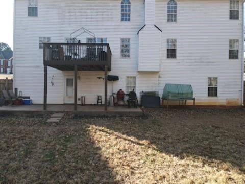 rear view of property with a patio and a yard