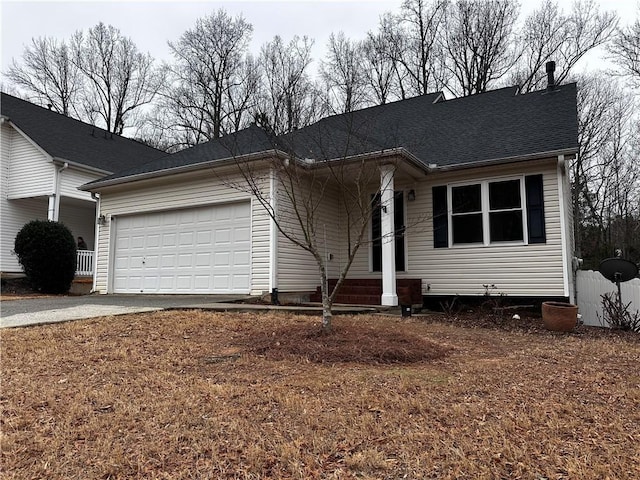 ranch-style home featuring an attached garage, driveway, and roof with shingles