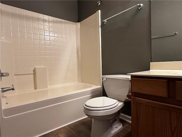 bathroom with vanity, toilet, wood finished floors, and shower / bathtub combination