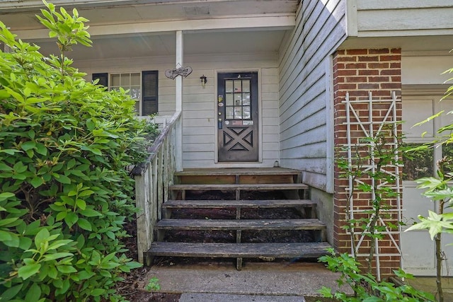doorway to property with brick siding