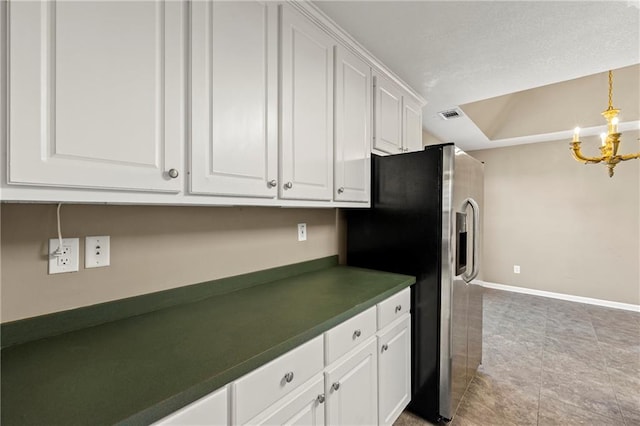 kitchen featuring white cabinetry, pendant lighting, stainless steel refrigerator with ice dispenser, and a notable chandelier