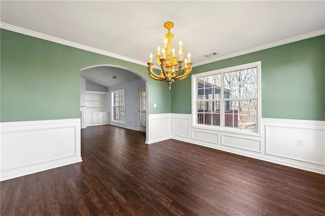 unfurnished dining area with a wealth of natural light, dark wood-type flooring, and a chandelier