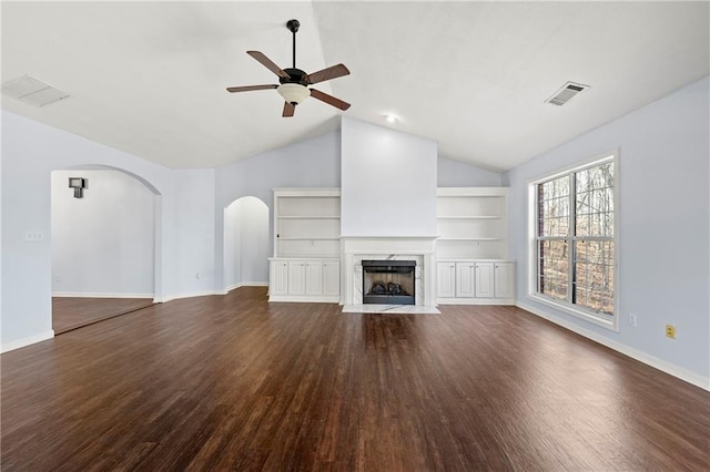 unfurnished living room with ceiling fan, dark hardwood / wood-style flooring, lofted ceiling, and a fireplace