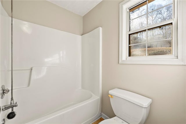 bathroom featuring toilet and shower / bath combination