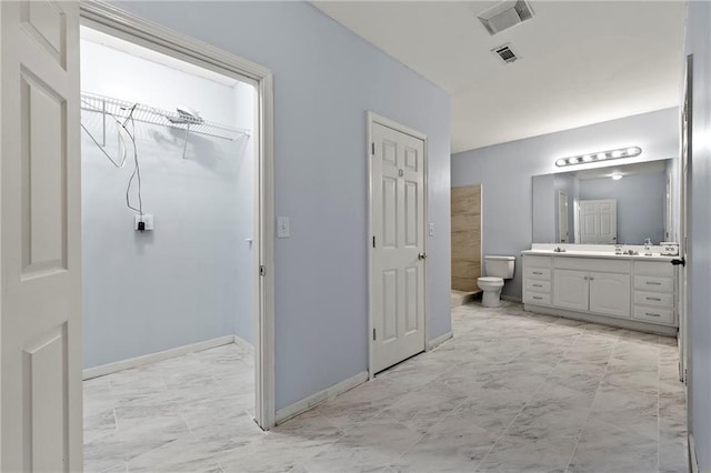 bathroom with vanity and toilet