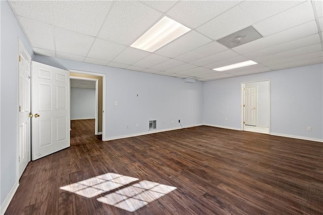 unfurnished room featuring a drop ceiling and dark hardwood / wood-style floors