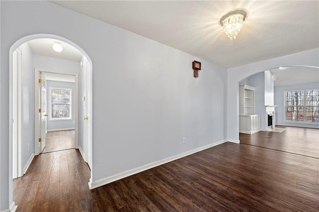 interior space with plenty of natural light and dark hardwood / wood-style floors