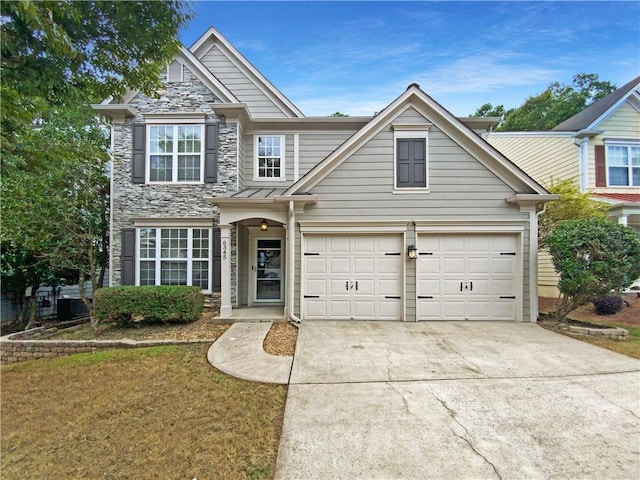 view of front of property featuring a garage and a front lawn