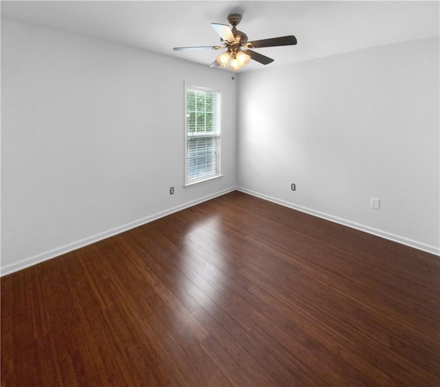 empty room featuring ceiling fan and dark hardwood / wood-style flooring