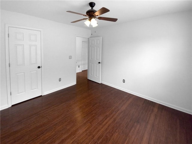 unfurnished bedroom featuring ceiling fan and dark hardwood / wood-style floors