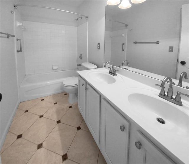 full bathroom with tiled shower / bath, toilet, and vanity