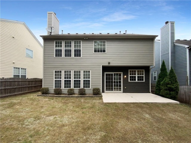 back of house featuring a yard and a patio area