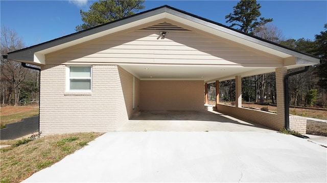 view of parking / parking lot with concrete driveway and a carport