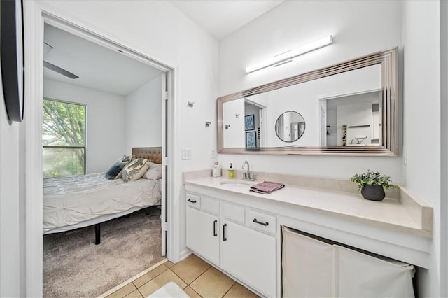 ensuite bathroom featuring vanity, ensuite bath, and tile patterned floors