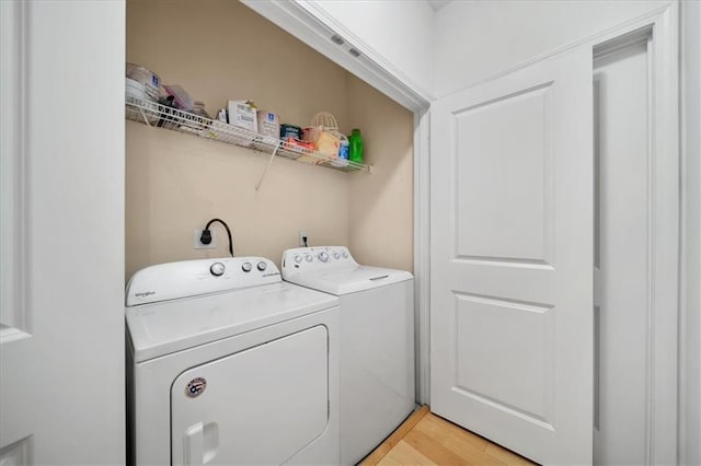 washroom featuring laundry area, light wood-style floors, and independent washer and dryer