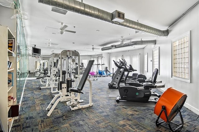 exercise room with carpet flooring, ceiling fan, visible vents, and baseboards