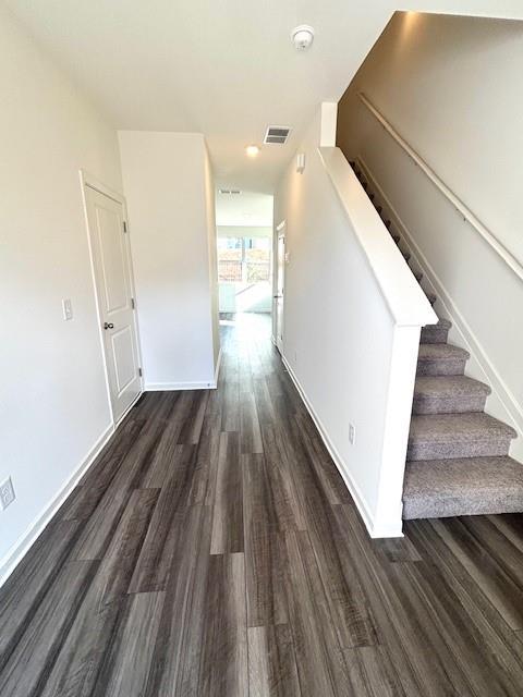 305 Winston Way, Villa Rica, GA 30180 - corridor featuring dark wood-type flooring, baseboards, and stairway