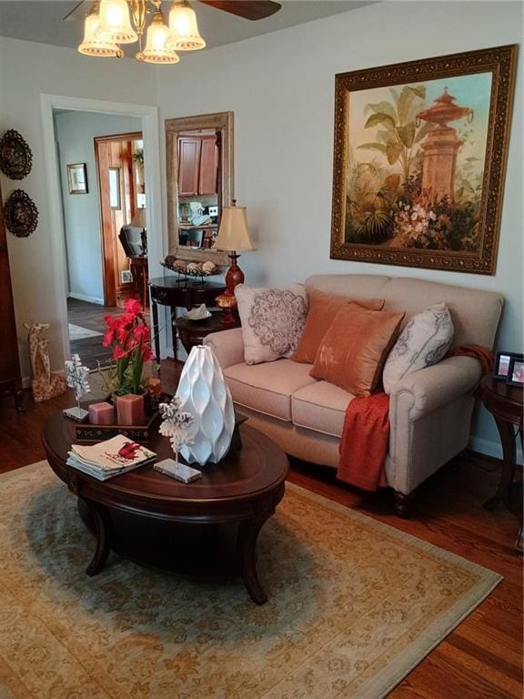 living area with an inviting chandelier and wood finished floors