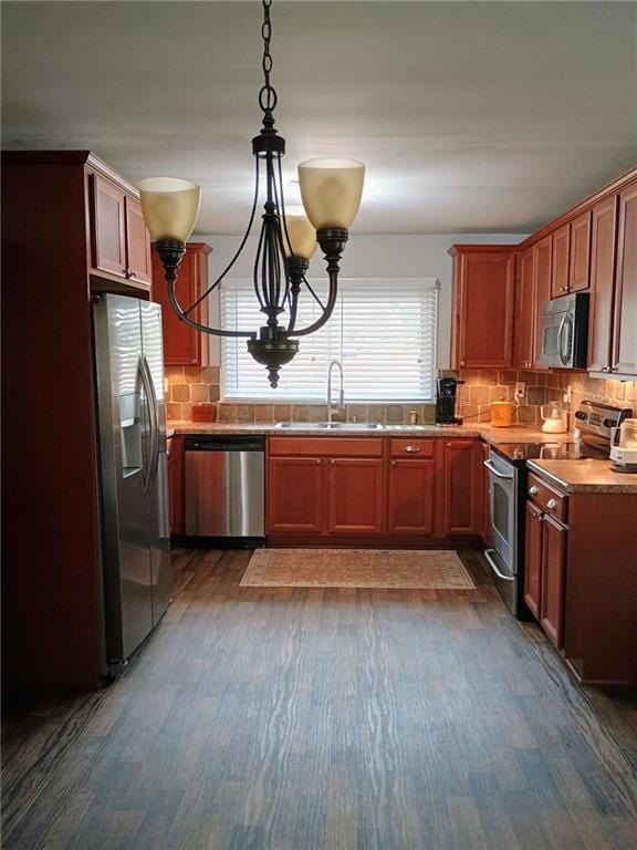 kitchen with a healthy amount of sunlight, decorative backsplash, stainless steel appliances, and a sink