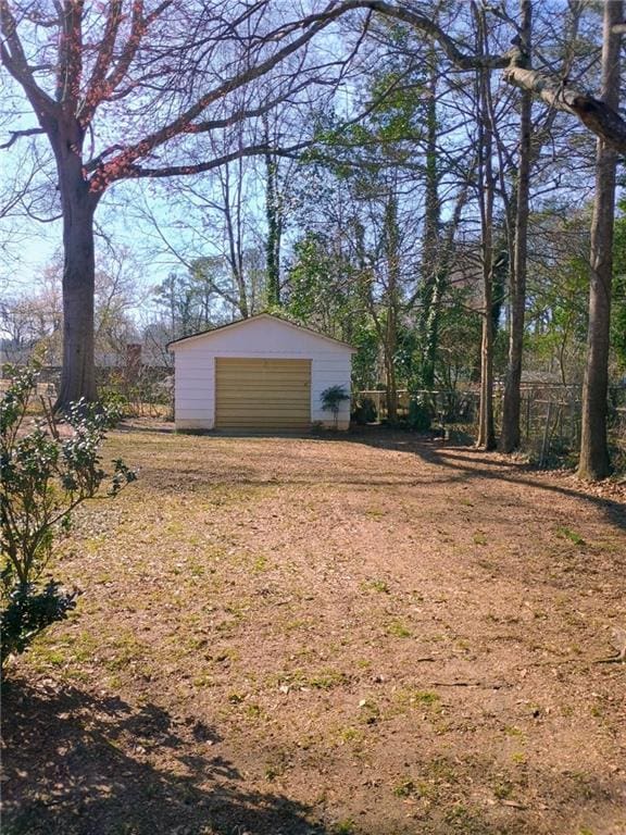 view of yard featuring a garage and an outdoor structure