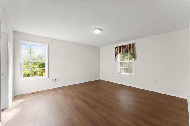 5523 Green Cir, Clermont, GA 30527 - empty room with wood finished floors, baseboards, and a textured ceiling