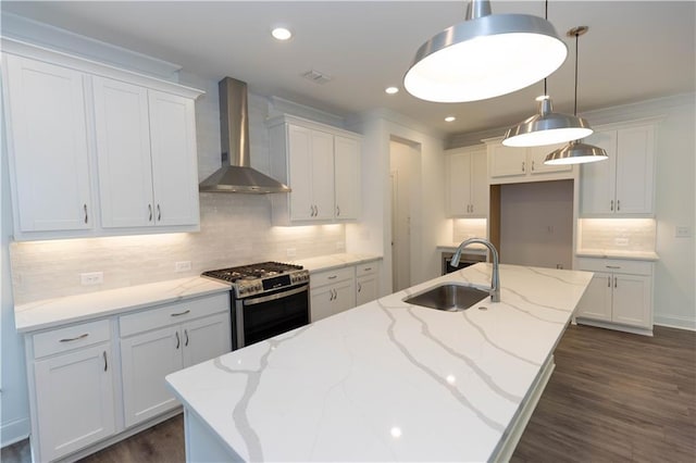 kitchen with white cabinetry, wall chimney exhaust hood, sink, and stainless steel gas stove