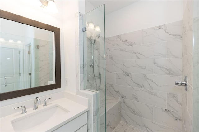 bathroom featuring vanity and tiled shower