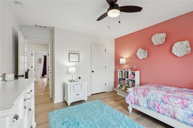 bedroom with light hardwood / wood-style flooring and ceiling fan