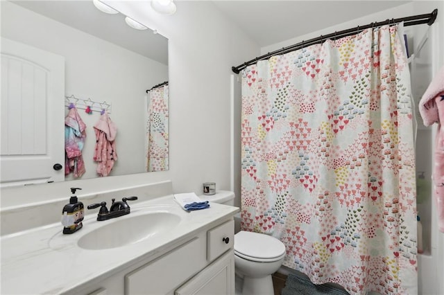 full bathroom with vanity, shower / bath combination with curtain, and toilet