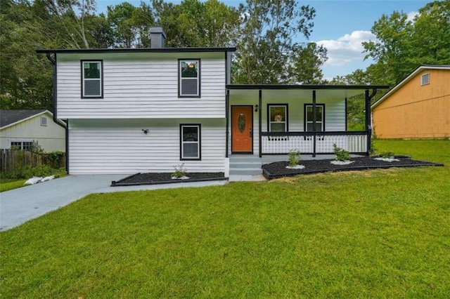 tri-level home with a front yard and covered porch