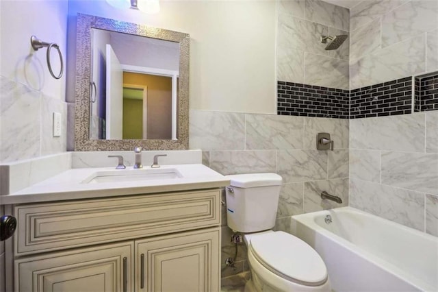 full bathroom with tile walls, vanity, tiled shower / bath combo, and toilet