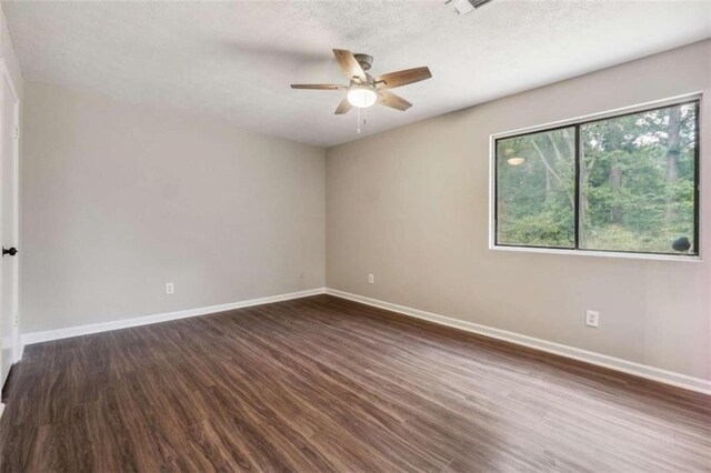 empty room with a textured ceiling, ceiling fan, and hardwood / wood-style flooring