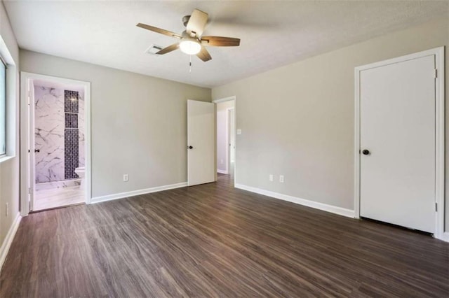 unfurnished bedroom featuring dark hardwood / wood-style flooring, connected bathroom, and ceiling fan