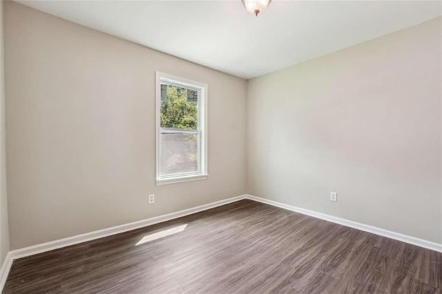 spare room with dark hardwood / wood-style floors