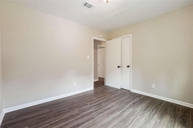 spare room with hardwood / wood-style floors