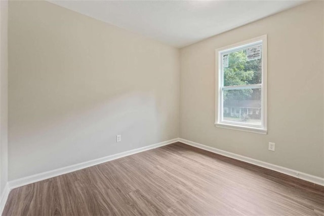 empty room with hardwood / wood-style flooring