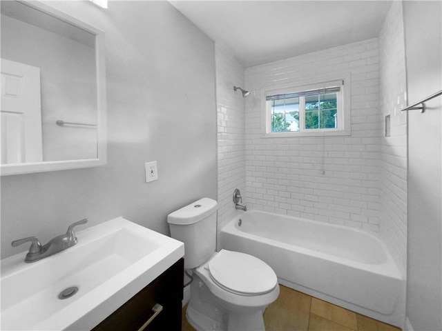 full bathroom featuring toilet, tiled shower / bath, and vanity