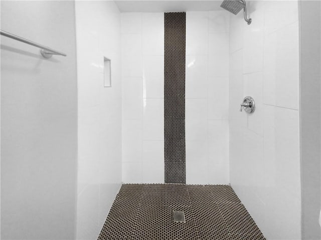 bathroom with a tile shower