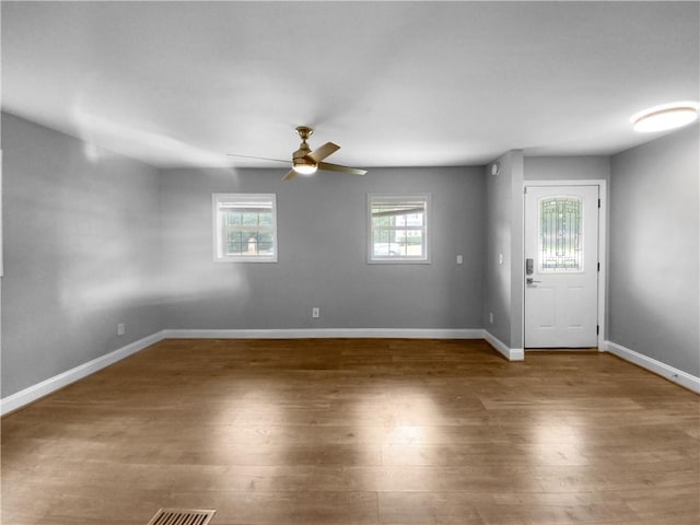 unfurnished room featuring ceiling fan and dark hardwood / wood-style flooring