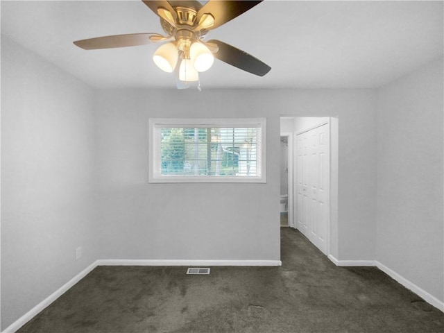 carpeted spare room featuring ceiling fan