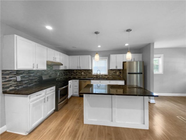 kitchen with sink, white cabinetry, appliances with stainless steel finishes, and a kitchen island