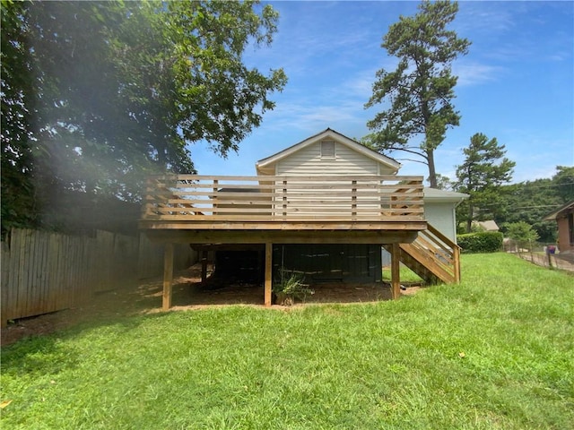 exterior space with a wooden deck and a lawn