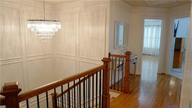 hall with a chandelier and wood-type flooring