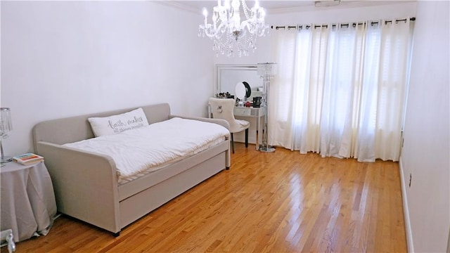 bedroom with hardwood / wood-style floors and a notable chandelier