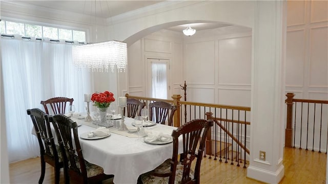 dining area featuring crown molding and light hardwood / wood-style flooring