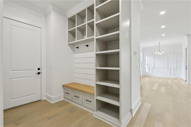 mudroom featuring light hardwood / wood-style flooring and a chandelier