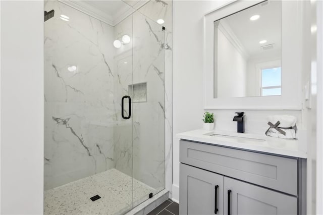 bathroom with tile patterned flooring, a shower with door, crown molding, and vanity