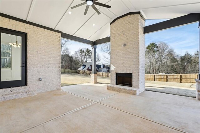 view of patio featuring ceiling fan and an outdoor brick fireplace