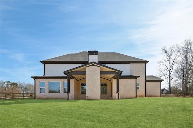 rear view of house with a lawn