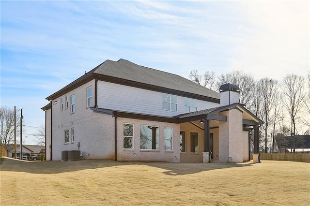 rear view of house with a yard